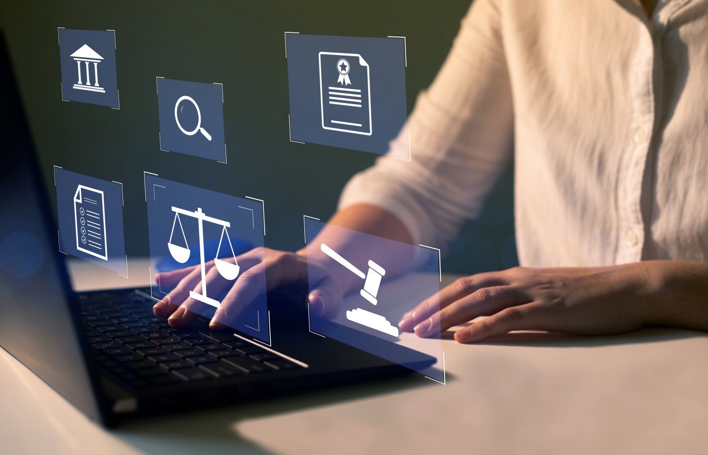hands at laptop keyboard with floating icons of gavel, scale, courthouse, documents, magnifying glass