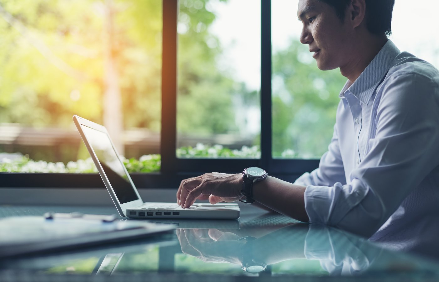 man typing on laptop