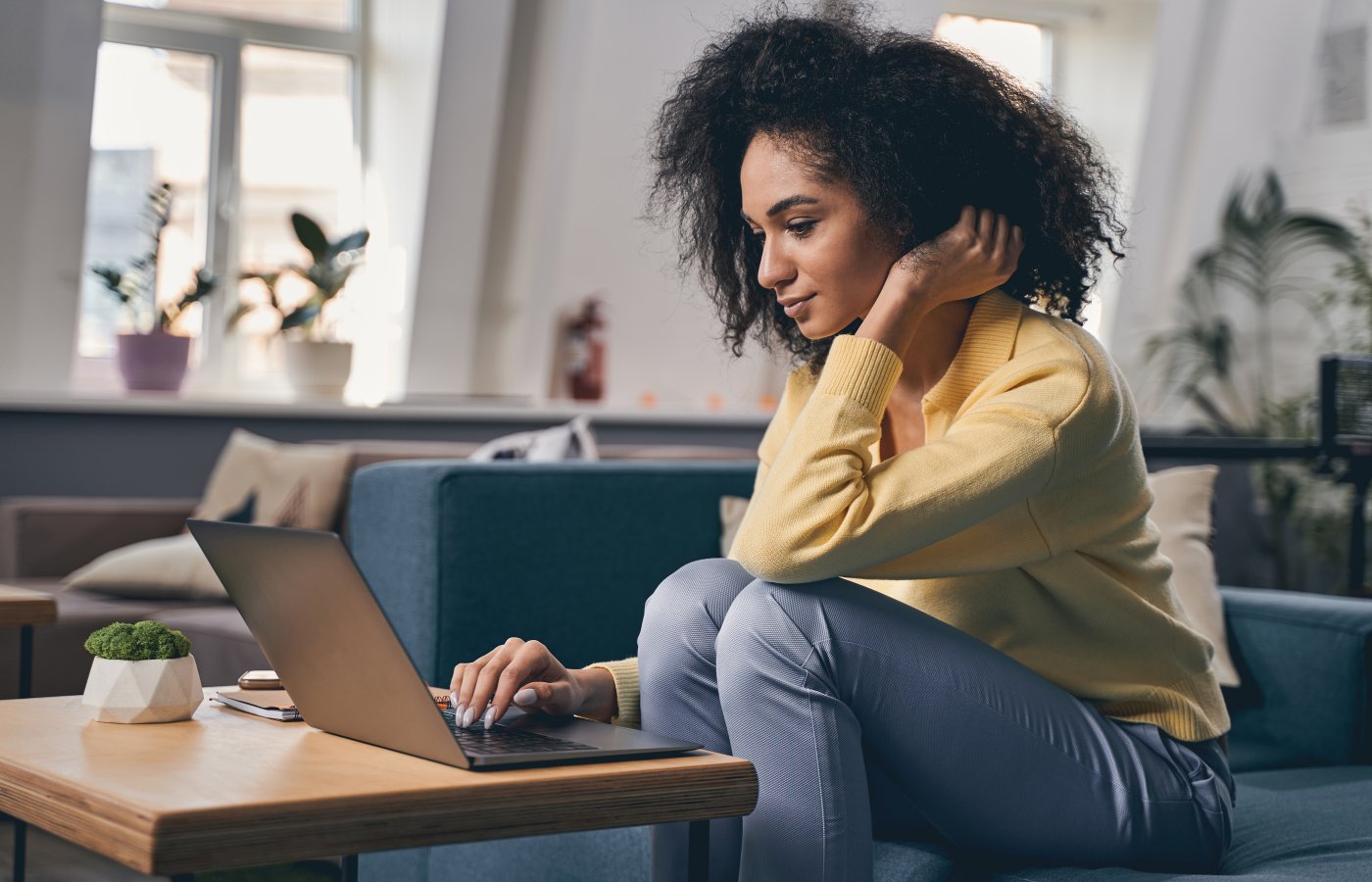 Woman sitting and looking at laptop