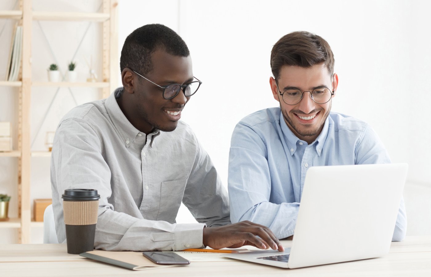 two men looking at computer