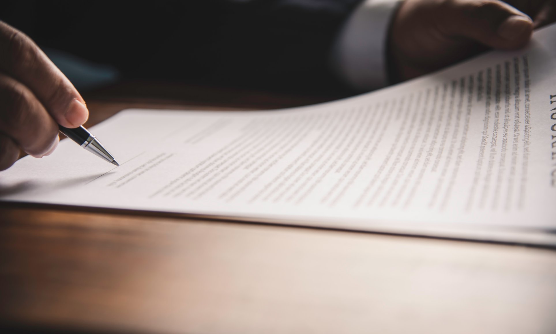 person holding paper with pen