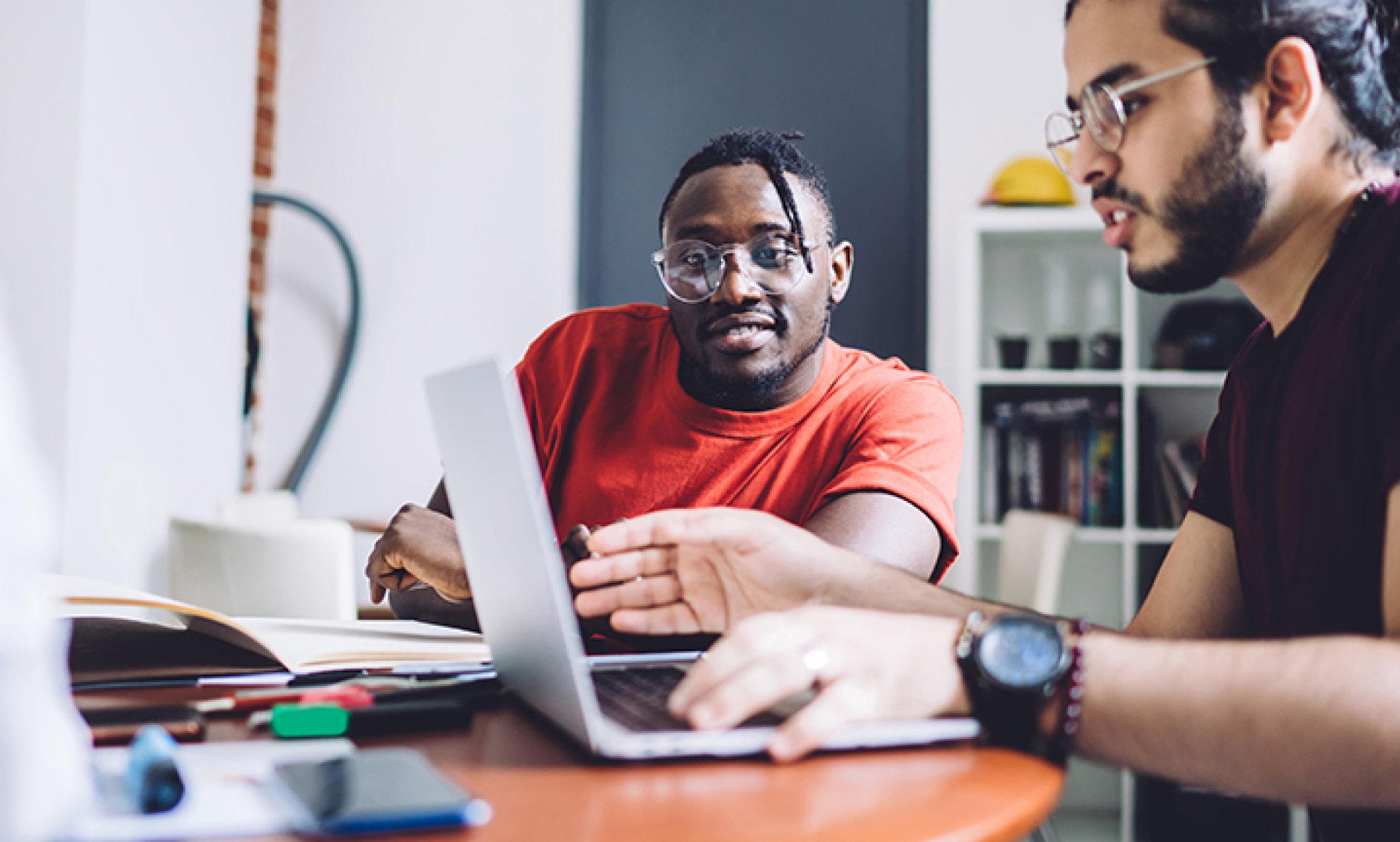 2 men looking at laptop