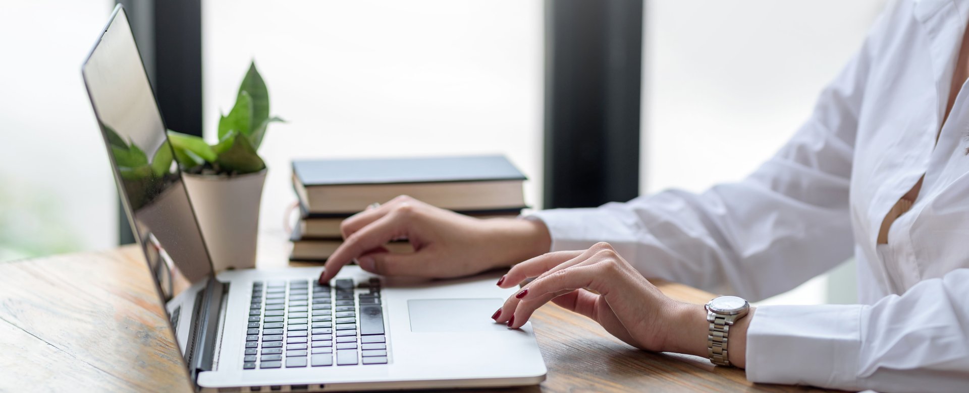 person pressing keys on laptop